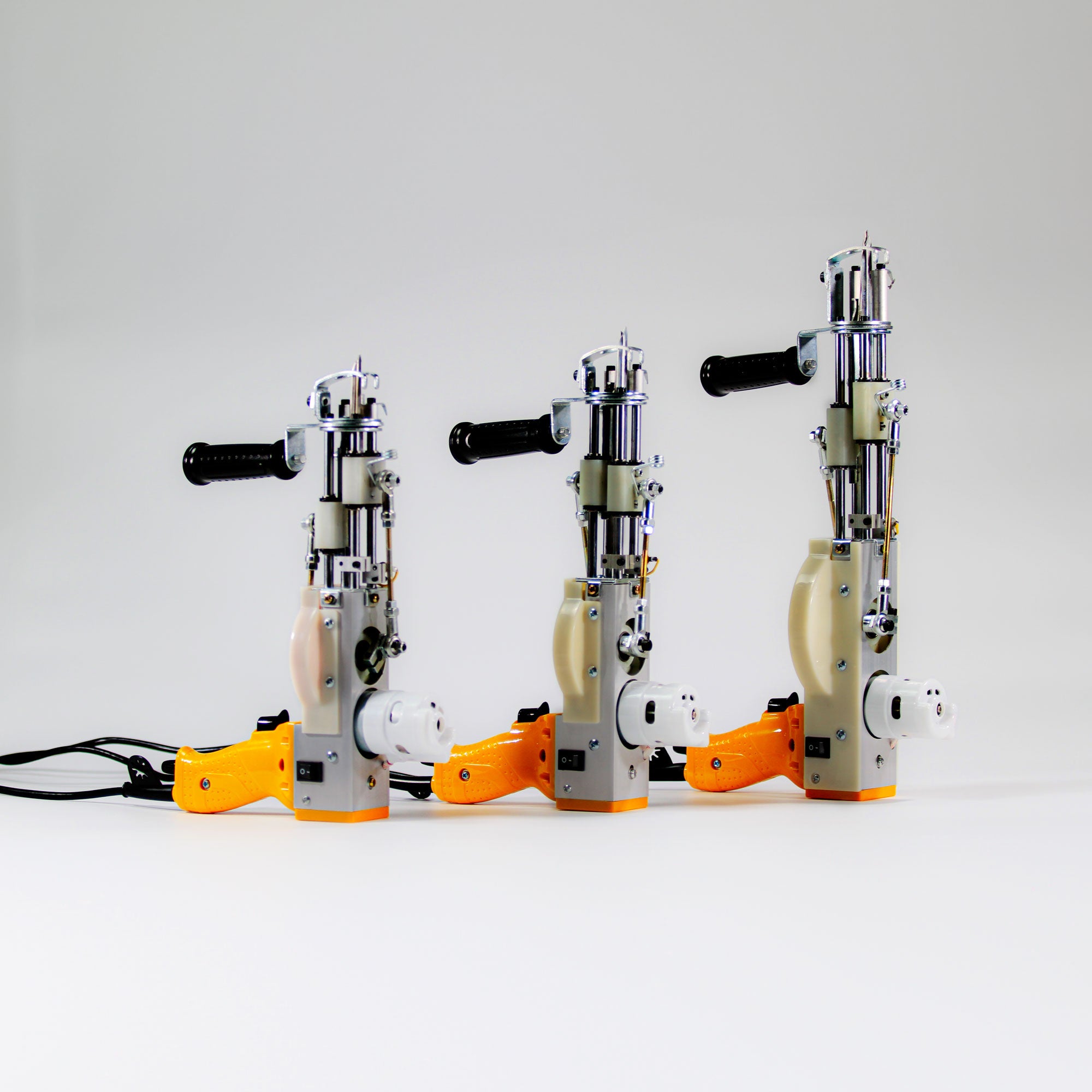 Three yellow AK DUO tufting machines – standard and high pile models for 10–40 mm rug tufting