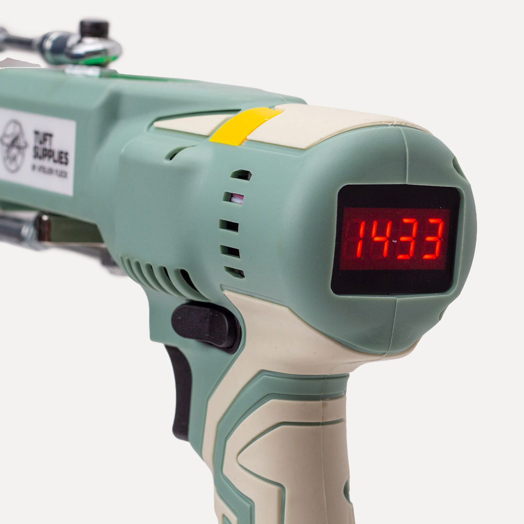 Close-up of a sage tufting machine that shows a display for the speed